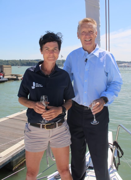 Ellen MacArthur on bow of yacht with man in suit