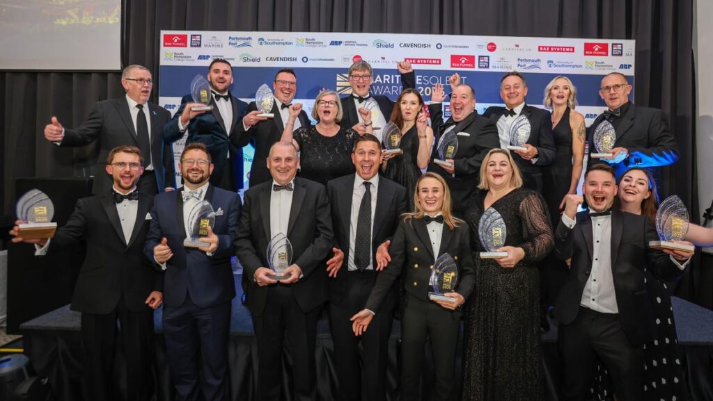 Group of business award winners holding their awards