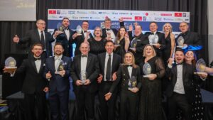 Group of business award winners holding their awards