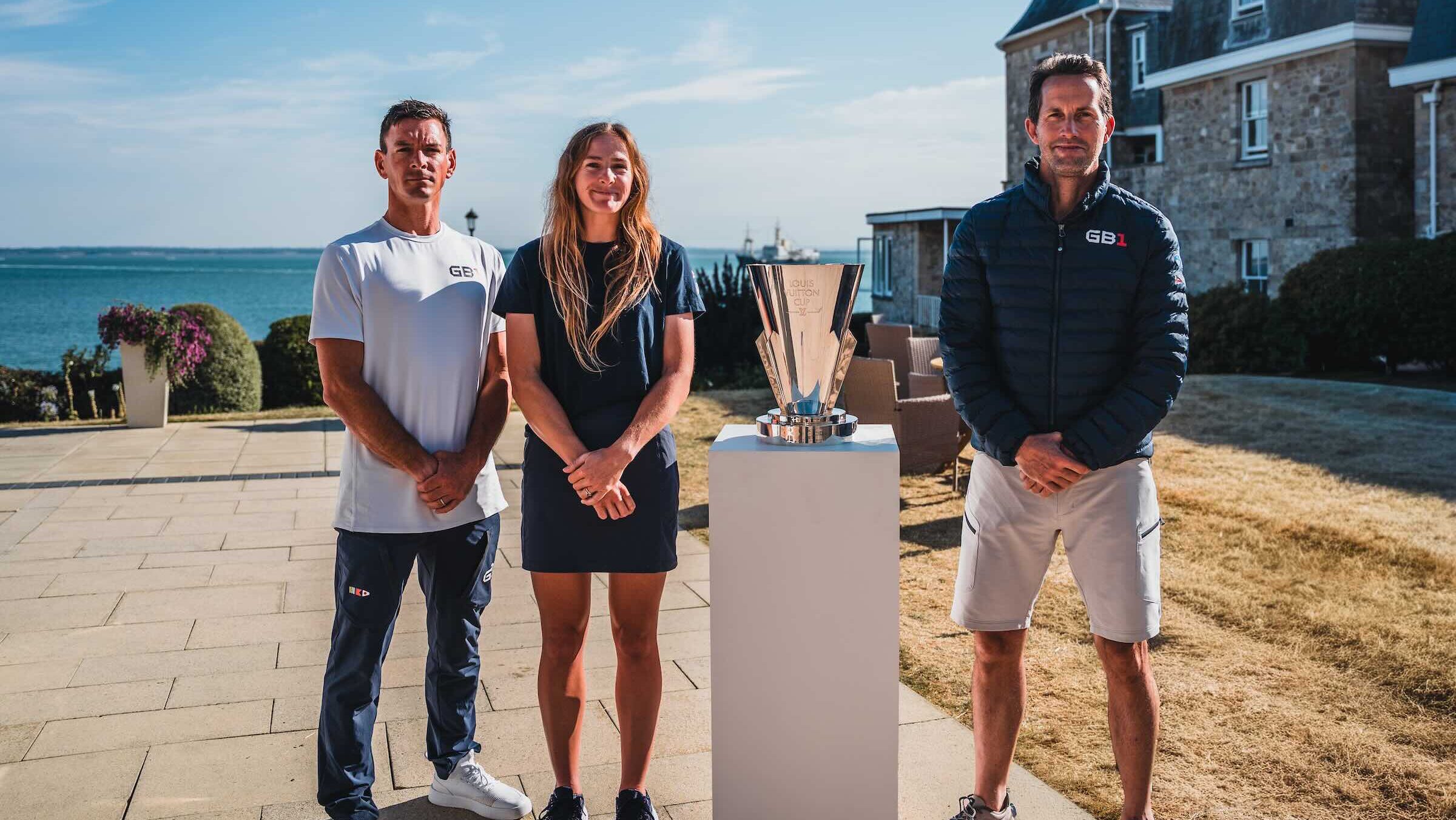 Dylan Fletcher MBE, Jemima Lines and Sir Ben Ainslie with the Louis Vuitton Cup at the Royal Yacht Squadron in Cowes, Isle of Wight