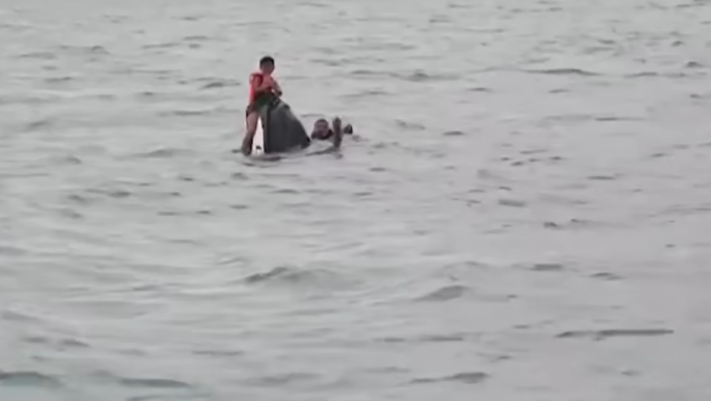 Rescuers approach the partially submerged jetski off Koh Samui
