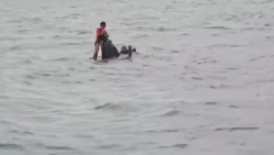 Rescuers approach the partially submerged jetski off Koh Samui