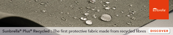 Close-up of water droplets on Sunbrella Plus Recycled fabric, highlighting its water-resistant and eco-friendly properties.
