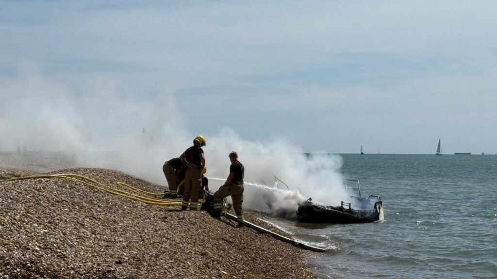 Smoking wreckage of a small boat fire
