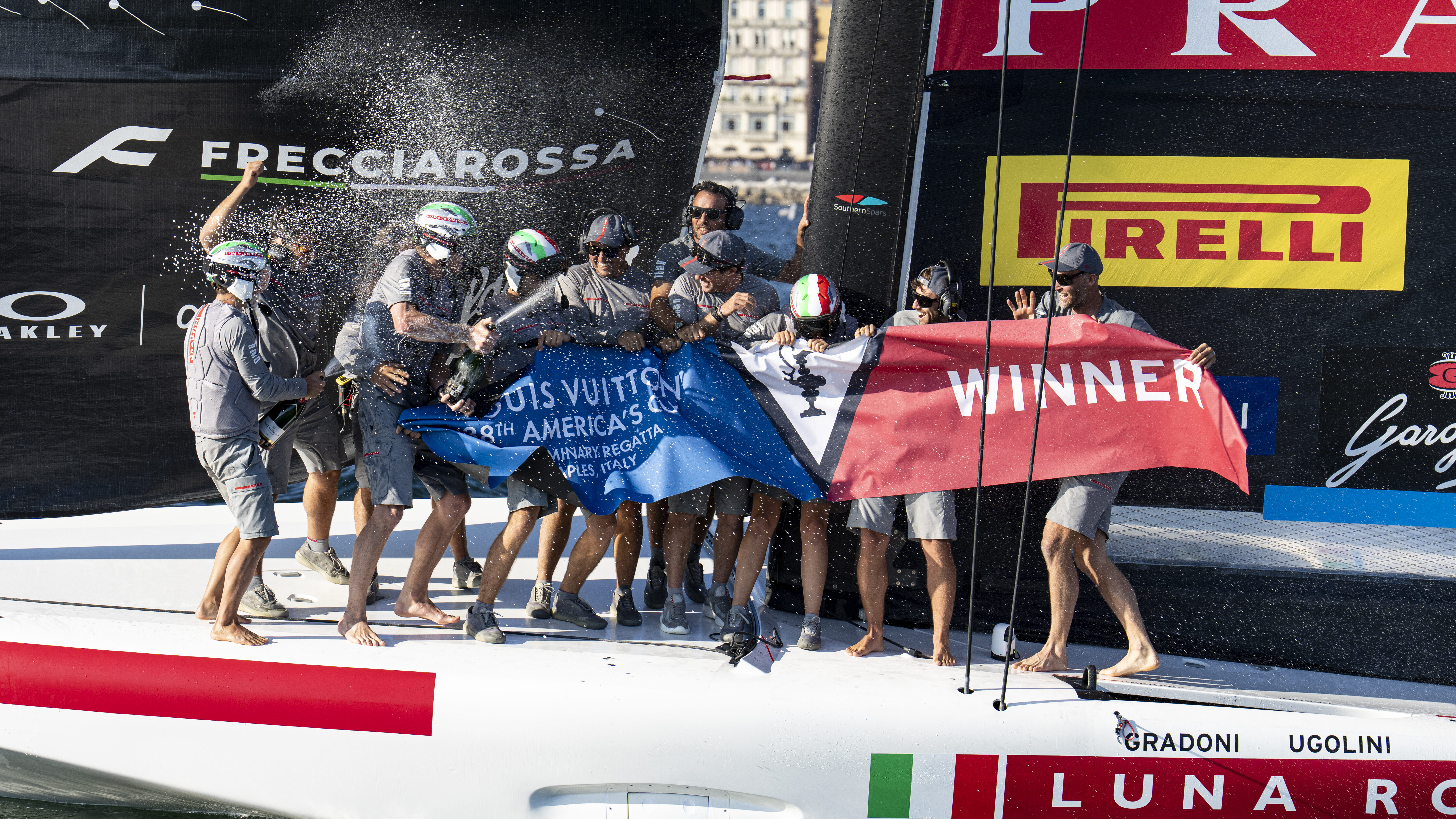 Luna Rosa team spraying champange after America's Cup win