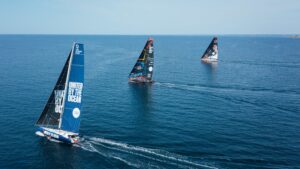 Three foiling IMOCA yachts sail across the Atlantic, with United by the Ocean leading the other two boats