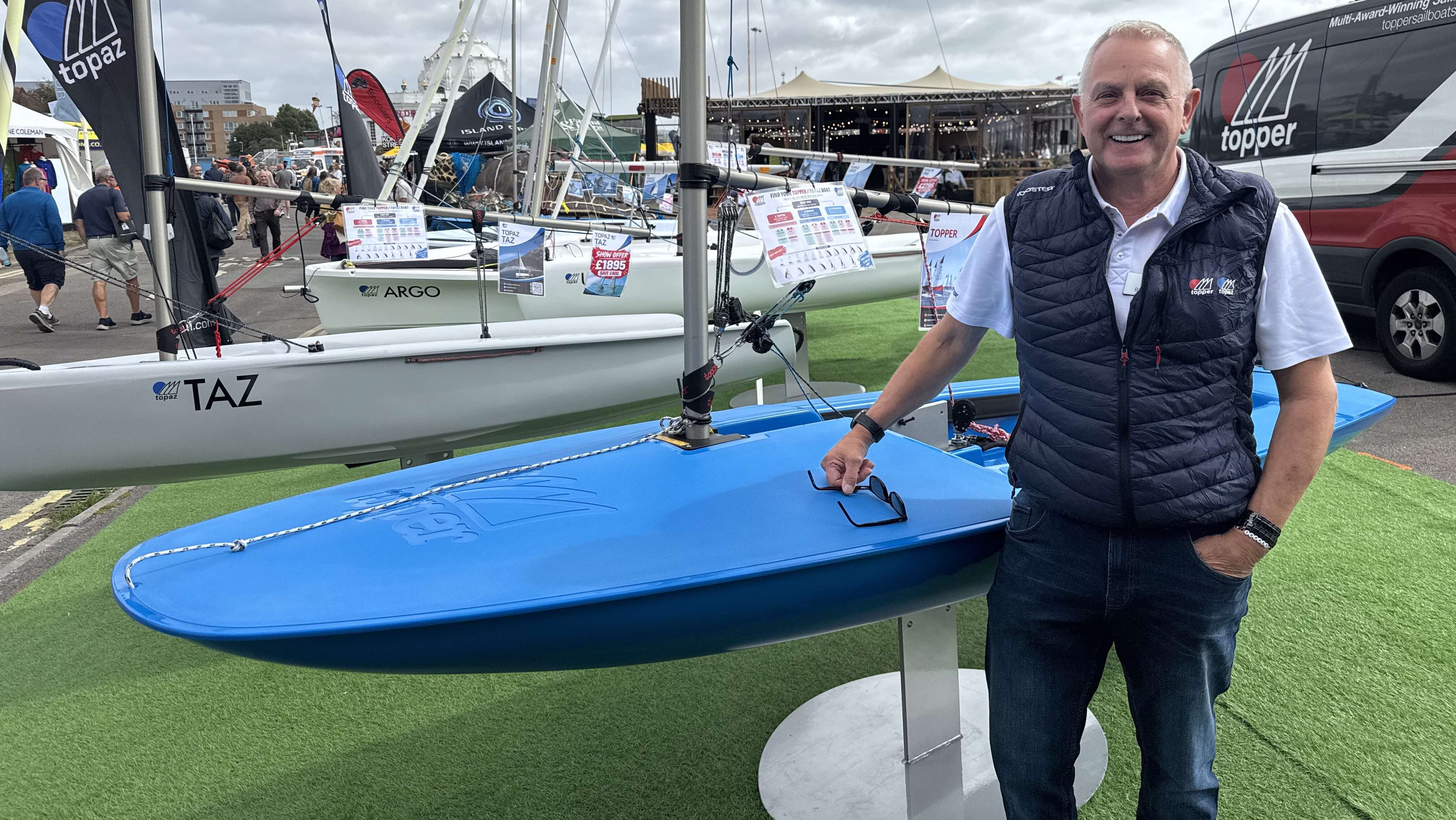 Russ Dent, sales and racing manager, Topper International standing by a blue topper at SIBS 2026