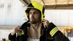 Firefighter wearing PPE helmet and buff