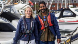 Woman and man on pontoon in life jackets smiling
