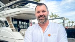 man in front of yacht smiling