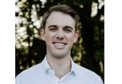 man smiling in white shirt